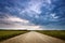 Evening country road with dramatic sky