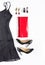 Evening dress outfit, night out look on white background. Little black dress, red clutch, black shoes, earrings, lipstick and nail