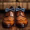 Evening elegance mans brown leather shoes with a bow tie