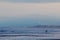 Evening on the empty beach. Blue sky with fuzzy image.