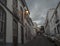 Evening empty narrow street at Santa Cruz de la Palma city center with glowing lantern, blue white traditional houses