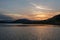 The evening lake reflected the mountains and the sky on both sides