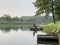 Evening landscape on a lake in the forest. Fishing, Sunset on a forest pond. Fishing platform on the river