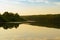 Evening landscape with lake and wooded shores