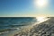 Evening landscape, sunset on the beach, dusk, ocean, dim sun and blue sky