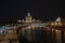 Evening landscape.View from the bridge to the waterfront. Moscow river.Dark sky.Beautifully illuminated buildings.