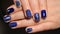 Evening manicure, design cold colors, blue gel polish with silver ribbons and pattern