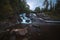 Evening mood in boreal forests of Norway. Waterfalls on river Homla