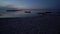 Evening or night panoramic sailing along the shore, beach, reeds, fishing wooden boats and island at sunrise or after