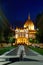 Evening photo of the Parliament building in Budapest. The majestic Saxon architecture is illuminated with warm yellow light