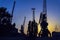 Evening in the port, sea, river dock. Silhouette of industrial cranes. Port landscape. Bright sunset