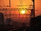 Evening on railway track with train in background.