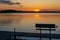 Evening scene at a Minnesota lake, with an emptly bench on a boat dock