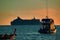 Evening seascape. Boats and ships at sunset. Silhouettes of ships. Warm tone.