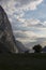 Evening shot of beautiful fjord valley, surrounded by mountains, cloudy blue skies