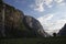 Evening shot of beautiful fjord valley, surrounded by mountains, cloudy blue skies