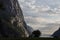 Evening shot of beautiful fjord valley, surrounded by mountains, cloudy blue skies