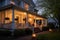 evening shot of a colonial house with lit side porch lanterns