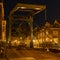 Evening shot of an old bridge The Kerkbrug on the Old Rhine river, with in the background the beautiful Hooglandse Kerkgracht, L