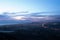 Evening sky with city lights and a coastal view