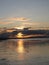 Evening sky with dark rainclouds and fiery sunlight reflections at Findhorn Bay, Scotland