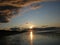 Evening sky with dark rainclouds and fiery sunlight reflections at Findhorn Bay, Scotland