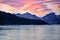 Evening sky with foehn clouds - Lenticularis clouds - over mountains reflecting in ocean with ice floes, South Georgia