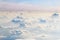 Evening sky over fluffy curly clouds. View from airplane. Beautiful skyline background. Soft focus