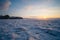 Evening sky during sunset on snowy frozen lake