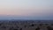 Evening skyline and sand dunes in wild desert. Cars moving along desert road