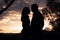 Evening skys backdrop frames serene couples touching silhouette scene