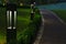 Evening square decorative lantern light on promenade area with small footpath trail in garden with beautiful electricity lights