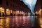 Evening streets of the old town with bright orange lanterns reflecting off the wet cobblestones in a storm with