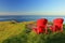 Evening Sun Shining on Red Adirondack Chairs at East Point on Saturna Island, Gulf Islands National Park, British Columbia, Canada