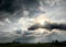 Evening sun throwing beams around storm clouds