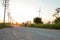 The evening sunset, The area of the wind turbine generates clean energy electricity, A woman is jogging on the road.