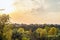 Evening sunset over the roofs of suburban houses. Autumn landscape in backlight sunlight.