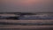 Evening, sunset over the sea, dark waves. Evening sea background