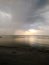 Evening sunset on the sea against the background of the oncoming rain front.