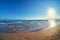 Evening surf and sunset at sandy beach