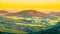 Evening in Tuscany. Hilly Tuscan landscape in golden mood at sunset time with silhouettes of cypresses and farm houses