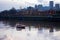 Evening urban Willamette river with modern small boat on water d