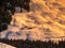 Evening view of alpine hut in the steep slope. Winter backountry ski touring area, Austrian Alps, Europe