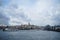Evening view of Galata tower district, bridge with people fishing and Bosporus sea water with boats, seagulls and cloudy sky