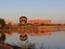 evening view of Lake Kopa: hot air balloon, houses, lake.