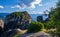 Evening view of typical Meteora landscape, Greece. Massive sedimentary rocks, cliffs, mountains, valley. Blue sky and