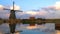 Evening view of windmill and water reflection