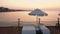 Evening view of wooden pier with sun loungers.