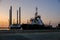 Evening view of Zayed Port with docked ships and oil rigs