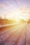 Evening winter landscape with the railway station. Snow-covered railway platform under the sun light at sunset. A place where peo